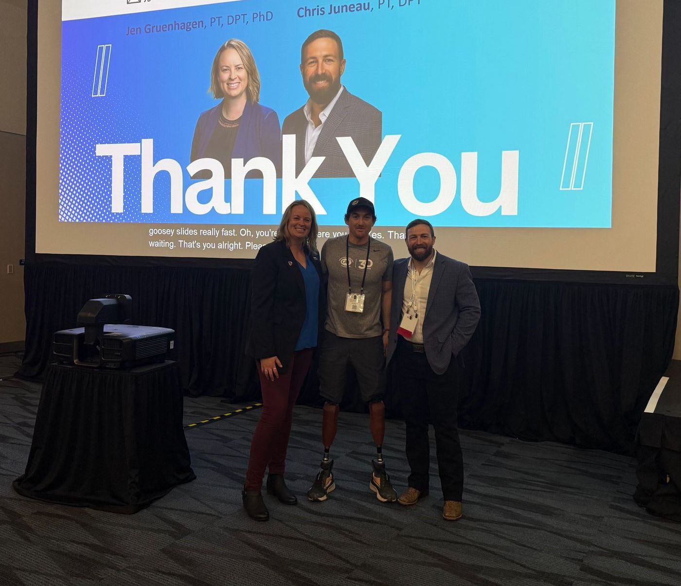 Chris on stage with Jen Gruenhagen and an athlete after a conference session